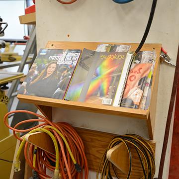 雕塑 magazines on a rack next to a drill press